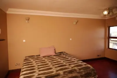 a bedroom with a bed with a pillow on it at Un-Furnished Rooms Contractors Accomodation at 66 Pongola Street, MIDDELBURG, Mpumalanga in Middelburg
