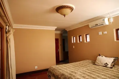 a bedroom with a bed and a ceiling at Un-Furnished Rooms Contractors Accomodation at 66 Pongola Street, MIDDELBURG, Mpumalanga in Middelburg