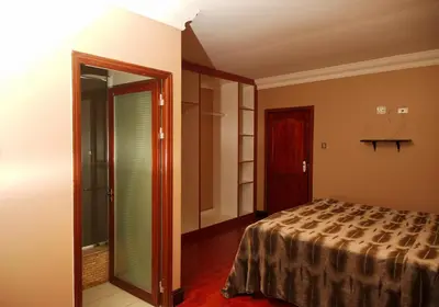 a bedroom with a bed and a sliding glass door at Un-Furnished Rooms Contractors Accomodation at 66 Pongola Street, MIDDELBURG, Mpumalanga in Middelburg