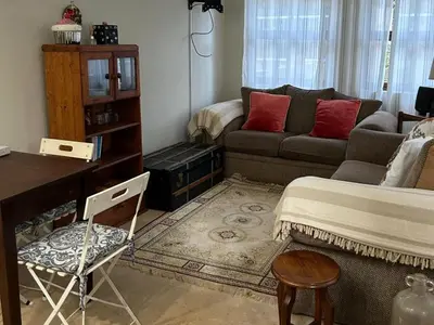 a living room with a bed and a couch at Legodimo Cottage in Dullstroom