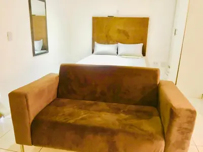 a couch in a room with a bed at Uncle Charles Guesthouse in Pretoria