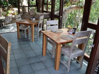 a wooden table and chairs on a patio at Willow Inn in Nelspruit