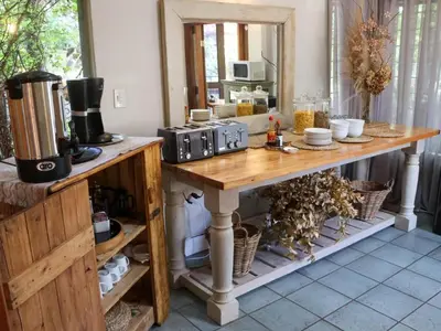 a kitchen with a table with two microwaves on it at Willow Inn in Nelspruit