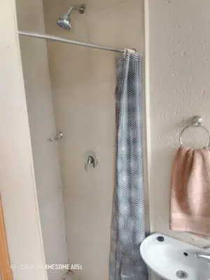 a bathroom with a shower with a toilet and a sink at Corporate or Contractors Beautiful Aerorand Apartment in Middelburg