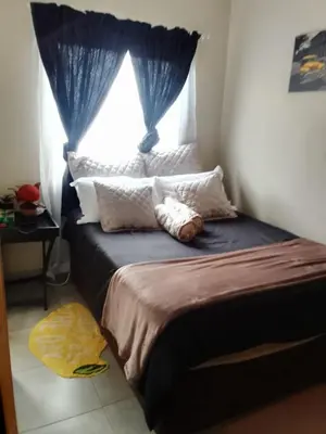 a bedroom with a bed with a window at Corporate or Contractors Beautiful Aerorand Apartment in Middelburg