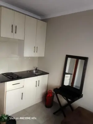 a kitchen with a mirror and a sink and a chair at Corporate or Contractors Beautiful Aerorand Apartment in Middelburg