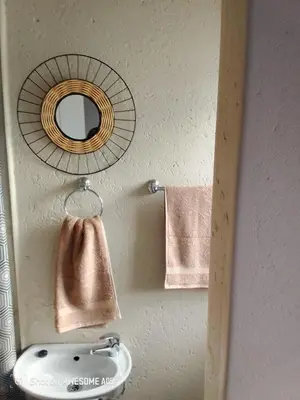 a bathroom with a sink and a mirror and towels at Corporate or Contractors Beautiful Aerorand Apartment in Middelburg