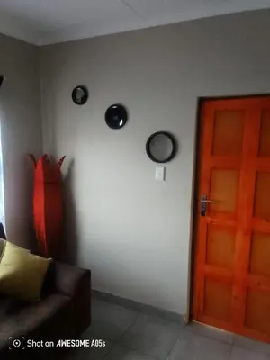 a living room with a couch and a door at Corporate or Contractors Beautiful Aerorand Apartment in Middelburg