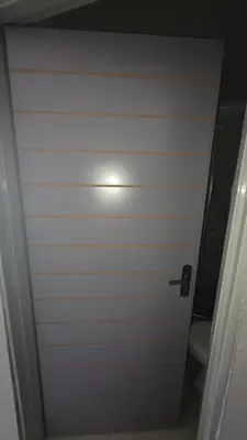 a door to a bathroom with a toilet and a light at Backyard Stay in Pretoria