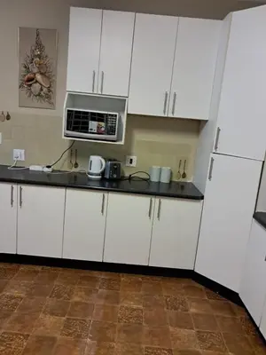 a kitchen with white cabinets and a microwave at Serene Exclusive Country Retreat in White River