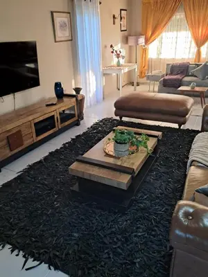a living room with a couch and a tv at Serene Exclusive Country Retreat in White River