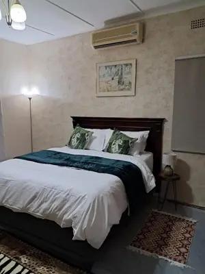 a bedroom with a large bed in a room at Serene Exclusive Country Retreat in White River