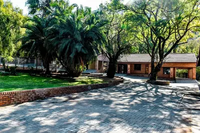a cobblestone driveway in front of a house at Phabema Guest House in Steelpoort
