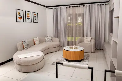 a living room with a couch and a coffee table at Closer to Home Luxury Apartments in Midrand