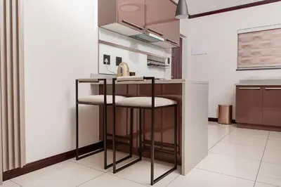 a kitchen with a counter with two bar stools at Closer to Home Luxury Apartments in Midrand