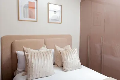 a bedroom with a bed with white pillows at Closer to Home Luxury Apartments in Midrand