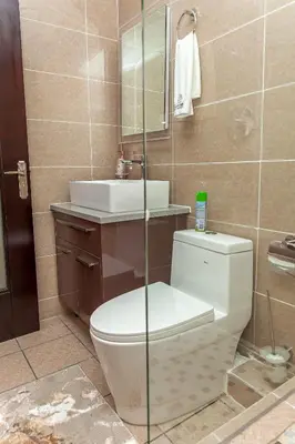 a bathroom with a toilet and a sink at Closer to Home Luxury Apartments in Midrand