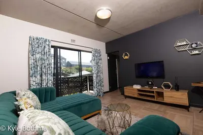 a living room with a couch and a tv at Smart Apartment Luxury in Midrand