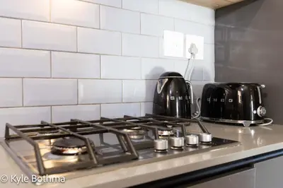 a stove top with pots and pans on top of it at Smart Apartment Luxury in Midrand