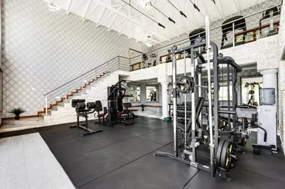 a gym with treadmills and machines in a room at Smart Apartment Luxury in Midrand