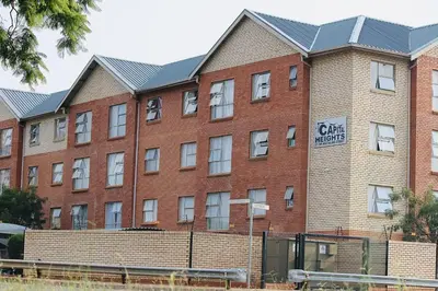 a red brick building with a sign on it at Capital Heights in Pretoria