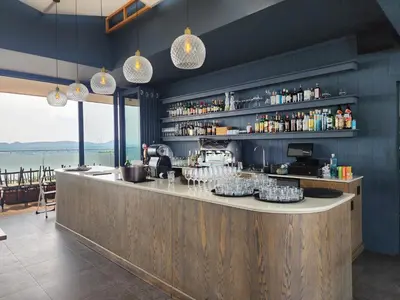 a bar in a restaurant with a view of the water at The Regal Studio at The Capital Trilogy in Pretoria