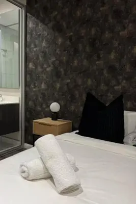 a bedroom with a bed with a towel on it at The Regal Studio at The Capital Trilogy in Pretoria