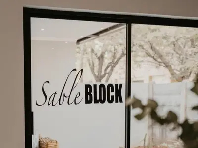 a sliding glass door with a sale block sign on it at Sable Block Self-Catering in Musina