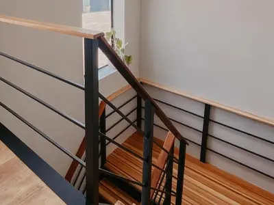 a stairwell with a wooden railing and a wooden floor at Sable Block Self-Catering in Musina