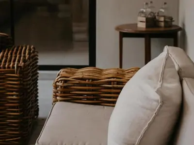 a couch with a basket sitting next to a table at Sable Block Self-Catering in Musina