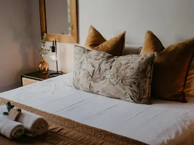 a bed with pillows and a towel on it at Sable Block Self-Catering in Musina