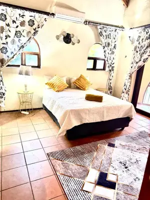 a bedroom with a bed in a room at Little Africa in Midrand in Randjesfontein