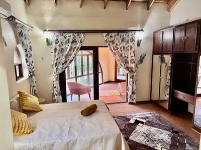 a bedroom with a large bed in a room at Little Africa in Midrand in Randjesfontein