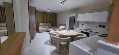 a kitchen with a table and chairs in a room at THE BLYDE CRYSTAL LAGOON F&S LUxurious Apartment 3bed in Pretoria