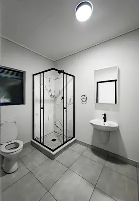 a bathroom with a shower and a toilet and a sink at THE BLYDE CRYSTAL LAGOON F&S LUxurious Apartment 3bed in Pretoria