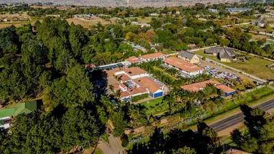 an overhead view of a house with a train in the yard at The Diplomat in Midrand