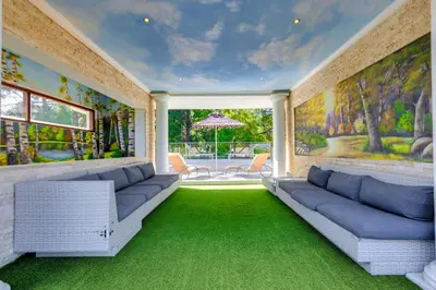 a living room with two couches and green carpet at The Diplomat in Midrand