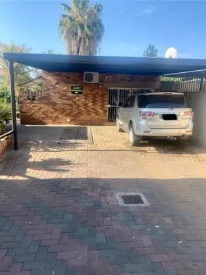 a car parked in front of a garage at Cozy Garden Flat with Garden in Pretoria