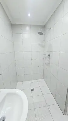 a white bathroom with a tub and a toilet at HMT Exquisite Spaces in Polokwane