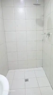 a white bathroom with a shower with a toilet at HMT Exquisite Spaces in Polokwane