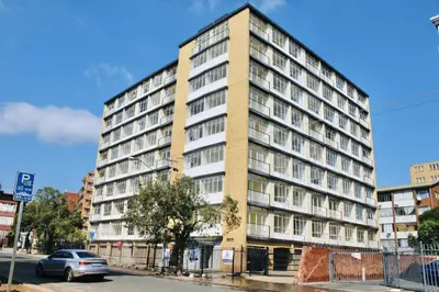 an apartment building on the corner of a street at Heideland in Pretoria
