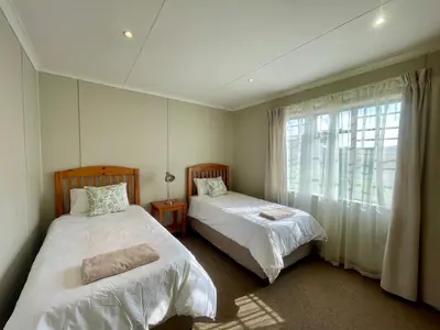 a bedroom with two beds and a window at Galil Farm in Crossroads