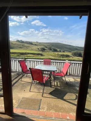 a view of a table and chairs from a window at Galil Farm in Crossroads