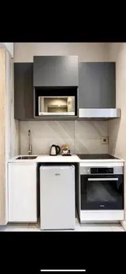 a kitchen with a stove and a microwave at Menlyn Main Apartments Trilogy in Pretoria