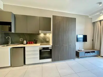 a kitchen with stainless steel appliances and a tv at Menlyn Main Apartments Trilogy in Pretoria