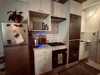 a small kitchen with a refrigerator and a stove at Loft On Grosvenor in Pretoria