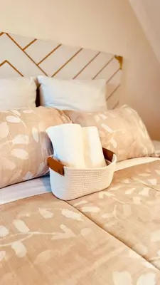 a bed with a basket on it with two beds at Loft On Grosvenor in Pretoria