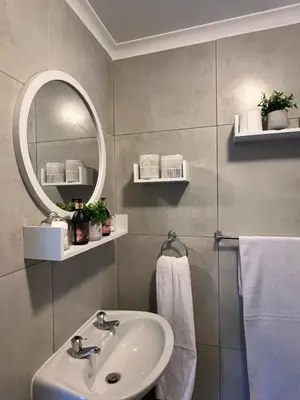 a bathroom with a sink and a mirror at Loft On Grosvenor in Pretoria