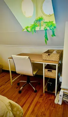 a desk with a white chair and a desk with a computer at Loft On Grosvenor in Pretoria