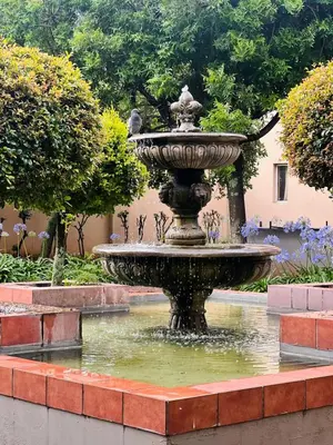 a fountain in the middle of a garden at Loft On Grosvenor in Pretoria